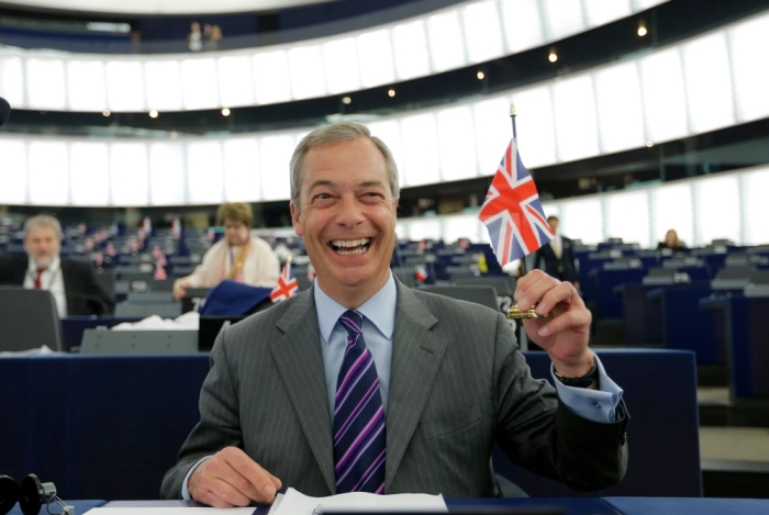 Nigel Farage, leader of the United Kingdom Independence Party and Member of the European Parliament holds a British Union Jack flag as he waits for the start of a debate at the European Parliament in Strasbourg, France, June 8, 2016.