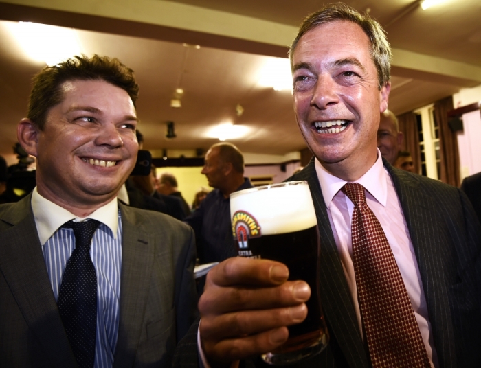 Nigel Farage, the leader of Britain's anti-EU party UKIP, enjoys a pint of beer as he celebrates after a hustings event at The Oddfellows Hall in Ramsgate, south east England August 26, 2014. Farage who is seeking a seat in parliament, was chosen by his party to run in a southern constituency controlled by the ruling Conservatives.
