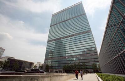 People walk in front of the United Nations Headquarters in New York July 31, 2008.