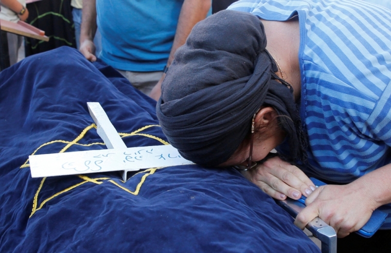 The mother of Israeli girl, Hallel Yaffa Ariel, 13, who was killed in a Palestinian stabbing attack in her home in the West Bank Jewish settlement of Kiryat Arba, mourns during her daughter's funeral at a cemetery in the West Bank city of Hebron June 30, 2016.