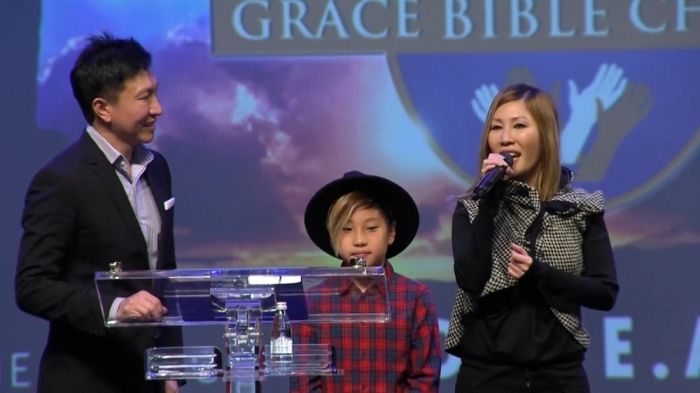 Kong Hee (L), his wife Sun Ho (R), and their son, Dayan (C) at a ministry event in Johannesburg in South Africa, video posted June 30, 2016.