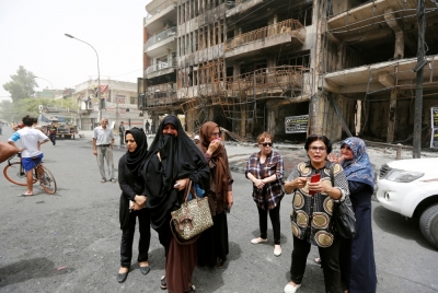 Women react at the site after a suicide car bomb attack at the shopping area of Karrada, a largely Shi'ite district, in Baghdad, Iraq July 4, 2016.
