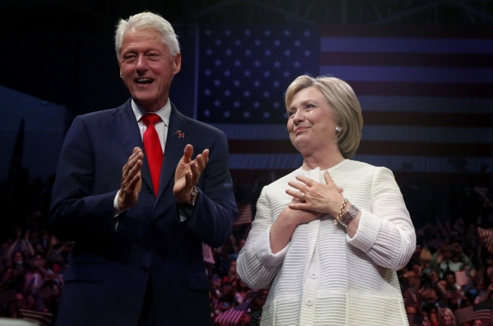 Democratic U.S. presidential candidate Hillary Clinton stands onstage with her husband former President Bill Clinton (L) after speaking during her California primary night rally held in the Brooklyn borough of New York, U.S., June 7, 2016.