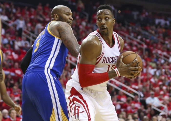 Houston Rockets turned Atlanta Hawks center Dwight Howard (12) attempts to spin around Golden State Warriors center Marreese Speights (5) during the third quarter in game three of the first round of the NBA Playoffs at Toyota Center. The Rockets won 97-96, Houston, Texas, April 21, 2016.