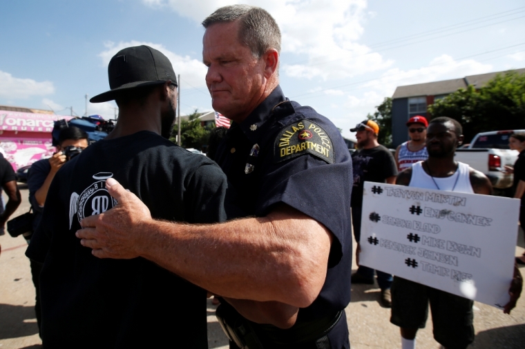 A Dallas police officer hugs a man following a prayer circle after a Black Lives Matter protest following the multiple police shootings in Dallas, Texas, July 10, 2016.