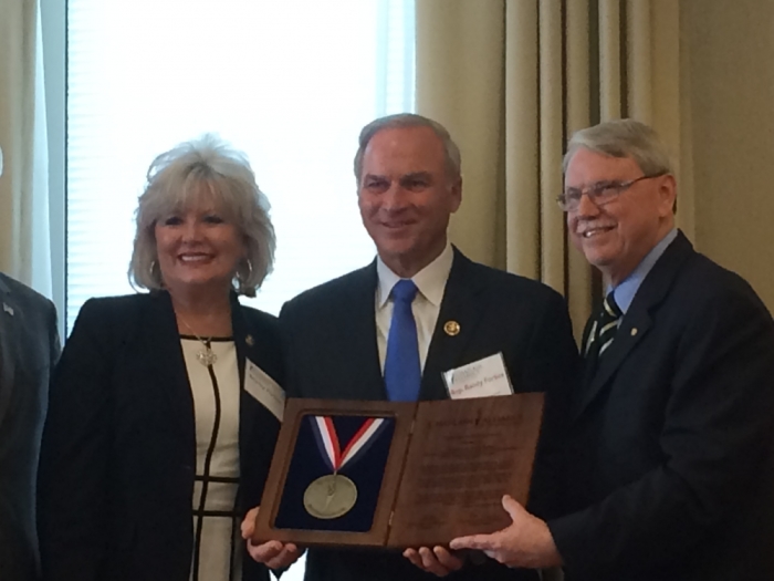 Ron Crews (L) of the Chaplain's Alliance for Religious Liberty presents Congressman Randy Forbes (center) the Torchbearer Award on July 12, 2016 in Washington, DC.
