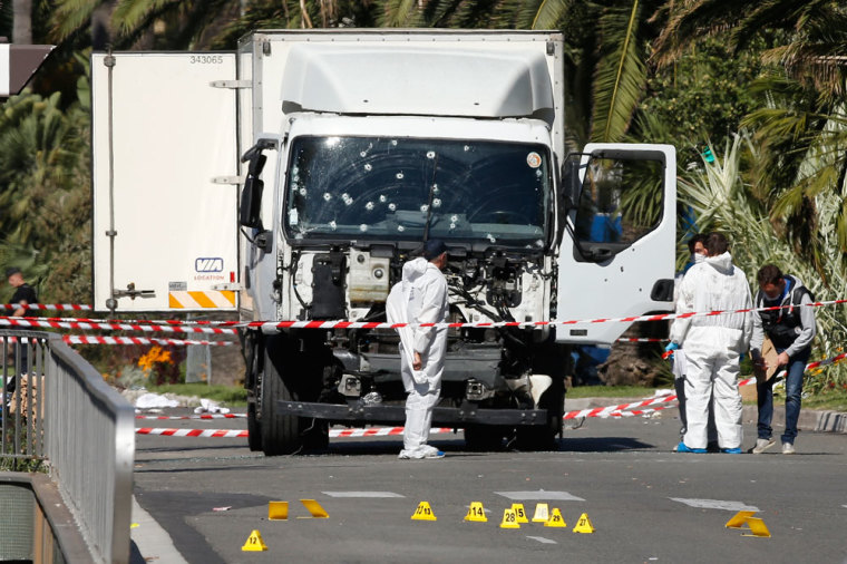 Investigators continue to work at the scene near the heavy truck that ran into a crowd at high speed killing scores who were celebrating the Bastille Day July 14 national holiday on the Promenade des Anglais in Nice, France, July 15, 2016.