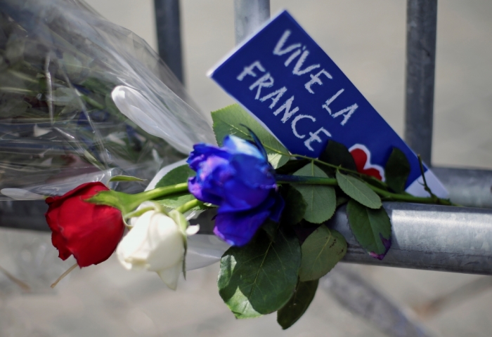 Flowers are seen attached to a fence to remember the victims of the Bastille Day truck attack in Nice in front of the French embassy in Rome, Italy, July 15, 2016.