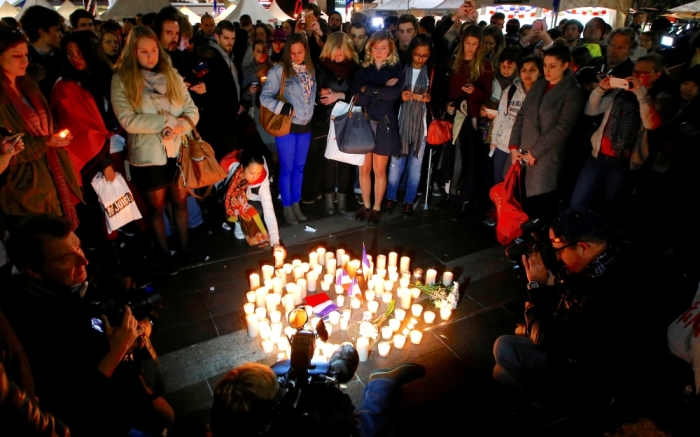 Members of the Australian French community stand around candles during a vigil in central Sydney, Australia, July 15, 2016, to remember the victims of the Bastille Day truck attack in Nice.