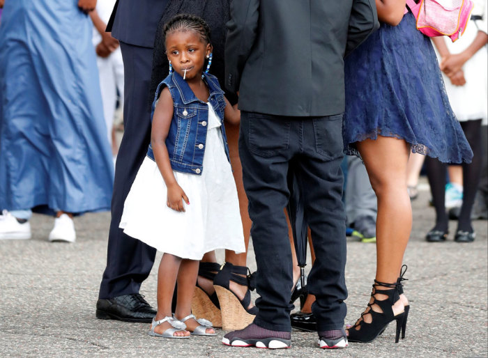Diamond Reynolds' daughter Dae'Anna looks on as the funeral procession for Philando Castile travels from the Brooks funeral home to the St Paul Cathedral in St Paul, Minnesota, U.S. July 14, 2016.