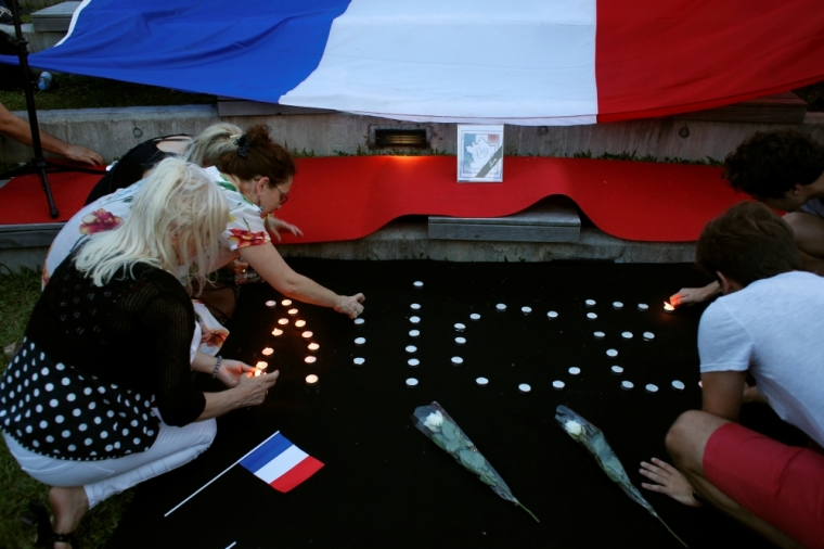 Members of the French community hold a gathering in Hong Kong, China, July 16, 2016, to mourn those killed in an attack in Nice, France.
