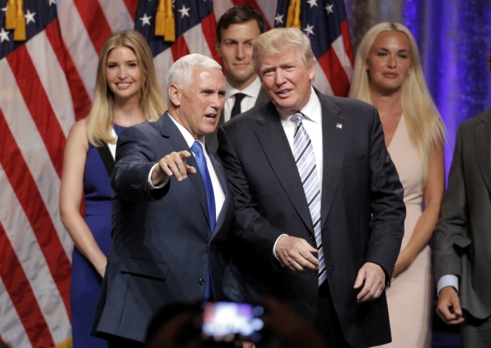 Republican U.S.presidential candidate Donald Trump (R) stands with Indiana Governor Mike Pence (L), as Trump family members look on after Pence was introduced as Trump's vice presidential running mate in New York City, U.S., July 16, 2016.
