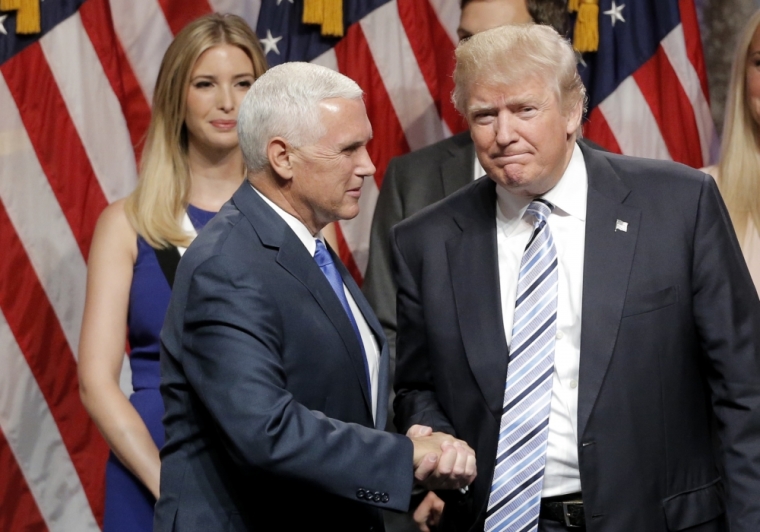 Ivanka Trump (L) looks on as her father, Republican U.S. presidential candidate Donald Trump (R), greets Indiana Governor Mike Pence as he introduces Pence as his vice presidential running mate in New York City, July 16, 2016.