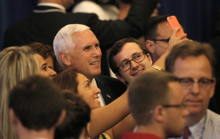 Indiana Governor Mike Pence poses for selfies with supporters at a news conference where he was introduced as the vice presidential running mate by Republican U.S. presidential candidate Donald Trump in New York City, U.S., July 16, 2016.