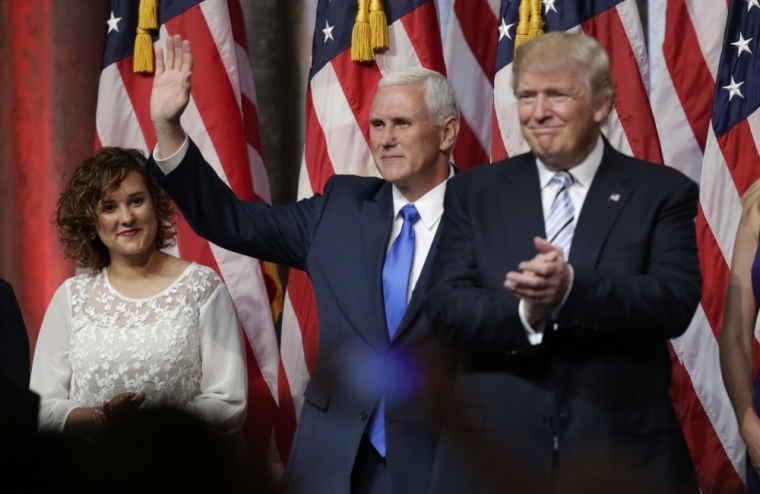 Republican U.S. presidential candidate Donald Trump (R) applauds and Indiana Governor Mike Pence waves as Pence's daughter Charlotte looks on at a press event held to introduce Pence as Trump's running mate in New York, July 16, 2016.