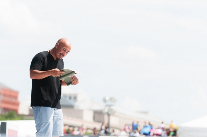 Francis Chan reads from the Bible as he addresses thousands of Christians gathered on the National Mall in Washington, D.C. for Together 2016 on July 16, 2016.
