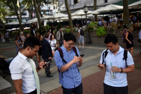 People play the augmented reality mobile game "Pokemon Go" by Nintendo in Bryant Park, New York City, July 11, 2016.