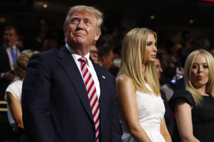 Republican U.S. presidential nominee Donald Trump stands in the Trump family box with his daughters Ivanka (C) and Tiffany (R) awaiting the arrival onstage of his son Eric at the conclusion of former rival Republican U.S. presidential candidate Senator Ted Cruz's address during the third night at the Republican National Convention in Cleveland, Ohio, U.S. July 20, 2016.