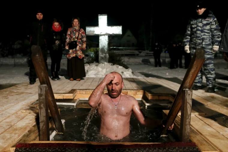 A man jumps into icy water during Epiphany celebration in the historic town of Pereslavl Zalessky, some 150 km (93 miles) from Moscow, January 19, 2016. Orthodox believers mark Epiphany on January 19 by immersing themselves in icy waters regardless of the weather.