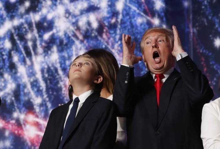 Republican U.S. presidential nominee Donald Trump reacts to balloons, confetti and electronic fireworks as he stands with his son Barron (L) at the conclusion of the final session of the Republican National Convention in Cleveland, Ohio, U.S. July 21, 2016.