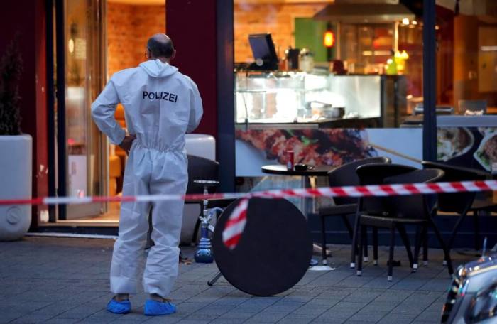 A police forensic expert works outside where a 21-year-old Syrian refugee killed a woman with a machete and injured two other people in the city of Reutlingen, Germany, July 24, 2016.