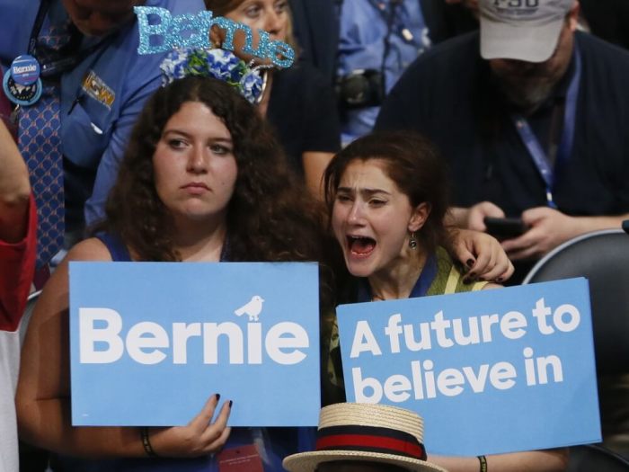 Two supporters of former Democratic presidential candidate Senator Bernie Sanders (D-VT) react as they listen to him speak at the Democratic National Convention in Philadelphia, Pennsylvania, U.S. July 25, 2016.