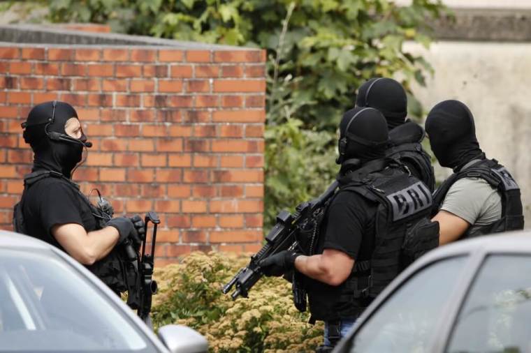 Members of French special police forces of Research and Intervention Brigade (BRI) are seen during a raid after a hostage-taking in the church in Saint-Etienne-du-Rouvray near Rouen in Normandy, France, July 26, 2016. A priest was killed with a knife and another hostage seriously wounded in an attack on a church that was carried out by assailants linked to Islamic State.