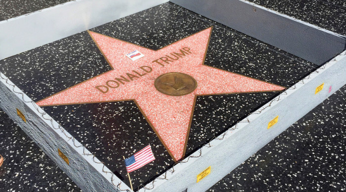 The Hollywood Walk of Fame Star awarded to Republican Presidential Nominee Donald Trump is shown surrounded by a barb-wire wall in a piece by street artist Plastic Jesus in Hollywood, California July 19, 2016.
