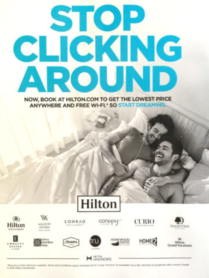 Hilton Worldwide full-page ad that features two men in bed together for the June 2016 issue of its magazine.