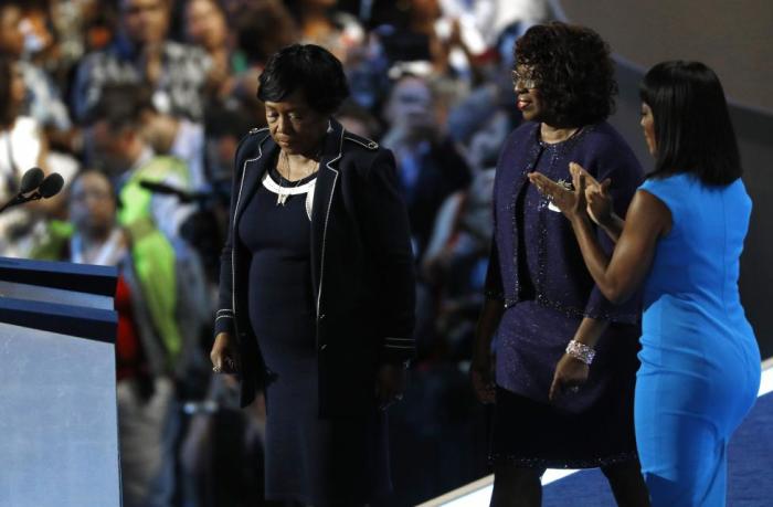 Actress Angela Bassett (R) applauds as Polly Sheppard (L) and Felicia Sanders take the stage at the Democratic National Convention on Wednesday July 27, 2016.