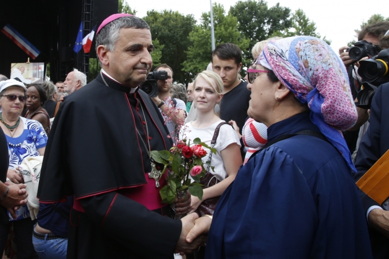 Archbishop of Rouen and Primate of Normandy Mgr Dominique Lebrun greets people in Saint-Etienne-du-Rouvray, near Rouen, France, who gather July 28, 2016 to pay tribute to French priest, Father Jacques Hamel, killed on Tuesday in an attack on the church that was carried out by assailants linked to Islamic State.