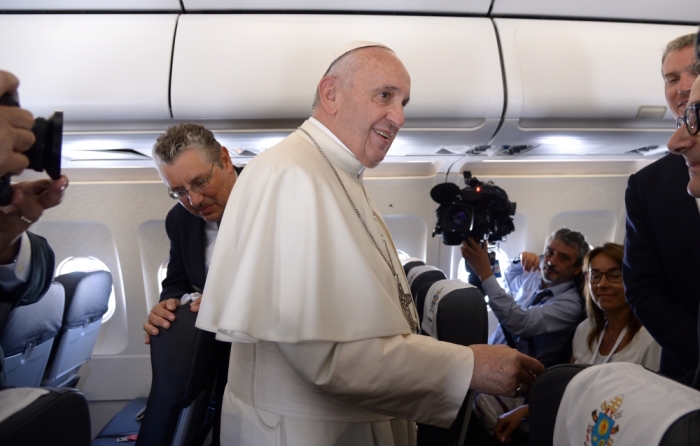 Pope Francis speaks on the plane as he travels from Italy to Poland, July 27, 2016.