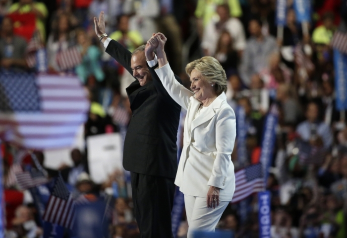 Democratic presidential nominee Hillary Clinton waves with her vice presidential running mate Senator Tim Kaine after accepting the nomination on the fourth and final night at the Democratic National Convention in Philadelphia, Pennsylvania, U.S. July 28, 2016.