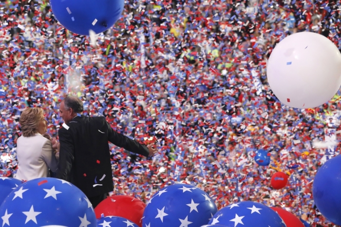 Democratic U.S. presidential nominee Hillary Clinton enjoys the balloon drop and confetti with her vice presidential running mate Senator Tim Kaine after accepting the nomination on the fourth and final night at the Democratic National Convention in Philadelphia, Pennsylvania, U.S., July 28, 2016.