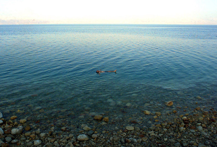 An Israeli man enjoys a swim in the Dead Sea, June 3, 2002. There were scant holidaymakers in the resort of Ein Gedi beach, an area that before the second Indifada hosted more than 100 buses of holidaymakers a day. The Palestinian suicide attacks and the Israeli army raids have kept tourists away from Israeli tourist destinations.