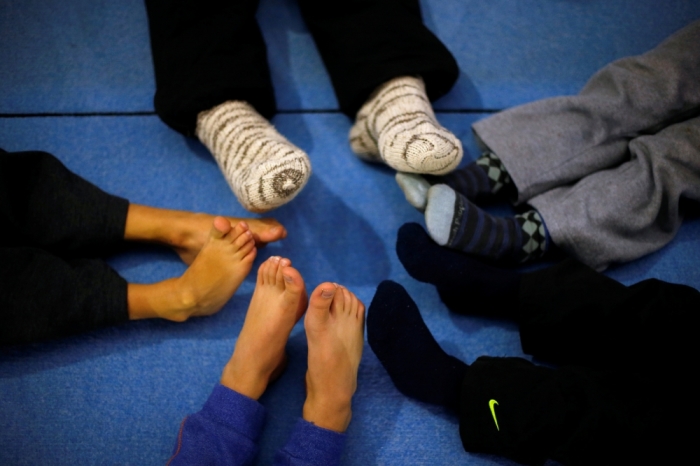 Children's feet are seen as they gather during a practice session at the school-gym of Tomas Gonzalez, the first Chilean gymnast to qualify twice for the Olympics, in Santiago, Chile, July 20, 2016.