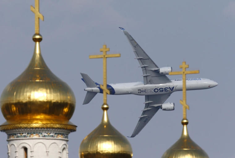 An Airbus A350 XWB aircraft flies over the domes of an Orthodox church during the MAKS International Aviation and Space Salon in Zhukovsky, outside Moscow, Russia, August 26, 2015.