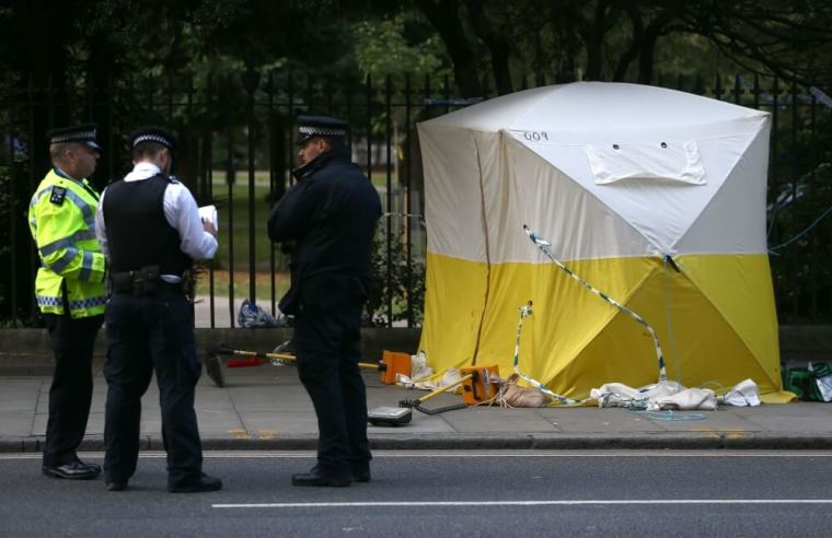 Police officers stand near a forensics tent after a knife attack in Russell Square in London, Britain, August 4, 2016.