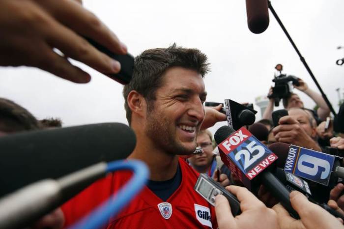 Newly-signed New England Patriots quarterback Tim Tebow talks to reporters following a practice session during a mandatory team mini-camp in Foxborough, Massachusetts, June 11, 2013.