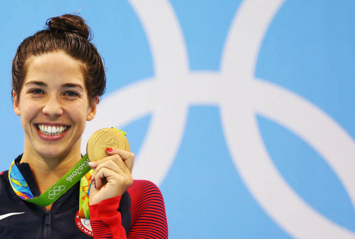 Maya DiRado of USA poses with her gold medal on the podium after winning the Women's 200m backstroke at the Olympic Aquatics Stadium in Rio de Janeiro, Brazil on August 12, 2016.