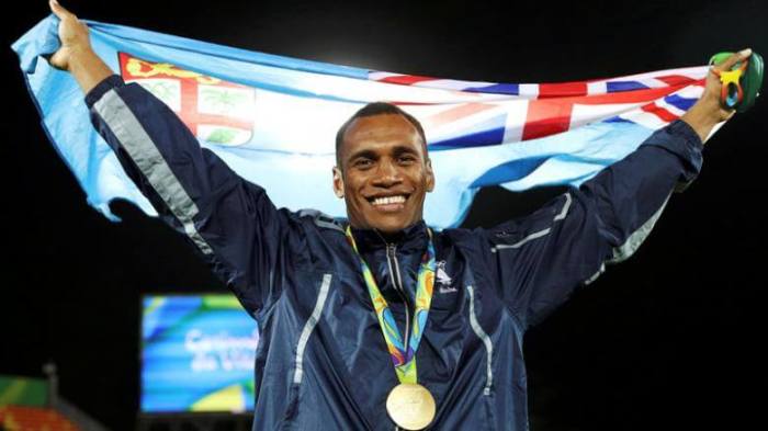 Osea Kolinisau (FIJ) of Fiji poses with his national flag and gold medal on August 11, 2016.
