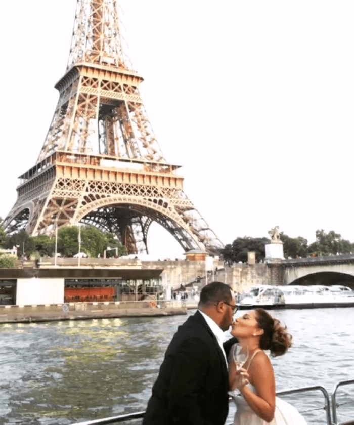 israel Hougton and Adrienne Bailon share a kiss in front of the Eiffel Tower, August 2106.