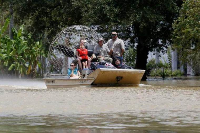 An airboat brings rescued residents to safety in Ascension Parish, Louisiana.