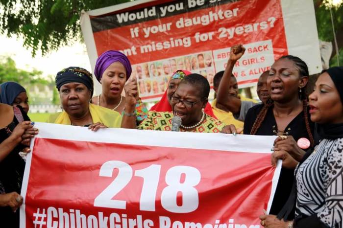 Members of the #BringBackOurGirls (#BBOG) campaign stand behind a banner with Number 218 during a sit-out in Abuja, Nigeria May 18, 2016, after receiving news that a Nigerian teenager kidnapped by Boko Haram from her school in Chibok more than two years ago has been rescued now making the number of kidnapped school girls now 218, no longer 219.