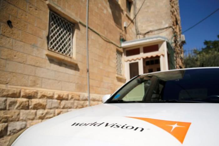 The logo of U.S.-based Christian charity World Vision is seen on a car parked outside their offices in Jerusalem, August 4, 2016.