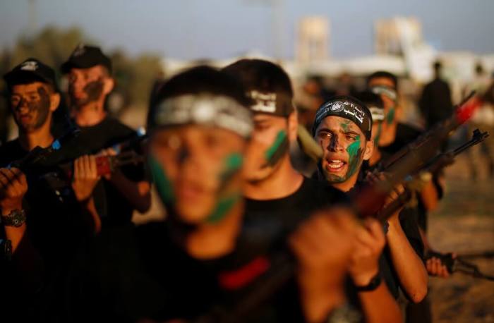 Young Palestinians take part in a military exercise graduation ceremony at a summer camp organised by Hamas's armed wing, east of Gaza City, July 22, 2016.