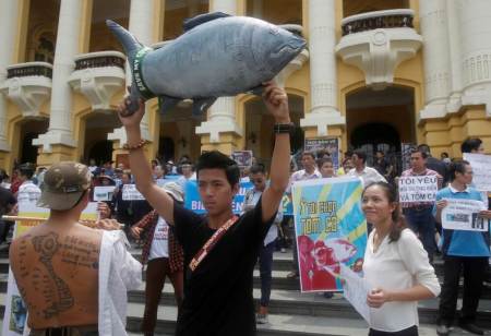 Demonstrators, holding signs of environmental-friendly messages, say they are demanding cleaner waters in the central regions after mass fish deaths in recent weeks, in Hanoi, Vietnam, May 1, 2016.