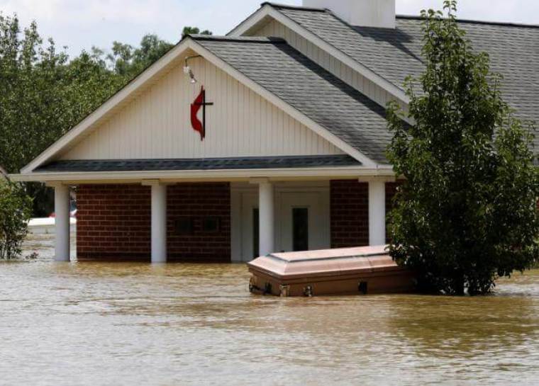 A casket is seen in front of a partially submerged church in Ascension Parish, Louisiana.