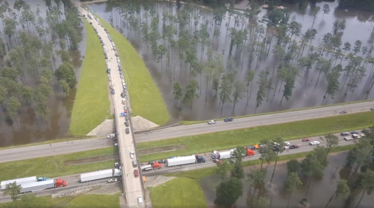 Motorists sit stranded by floodwaters on Interstate 12 in Livingston Parish, Louisiana, in this still image from video taken August 14, 2016.