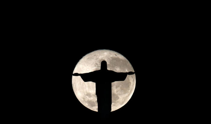 The full moon is pictured behind the Christ the Redeemer statue ahead of the 2016 Rio Olympic games in Rio de Janeiro, Brazil, July 19, 2016.